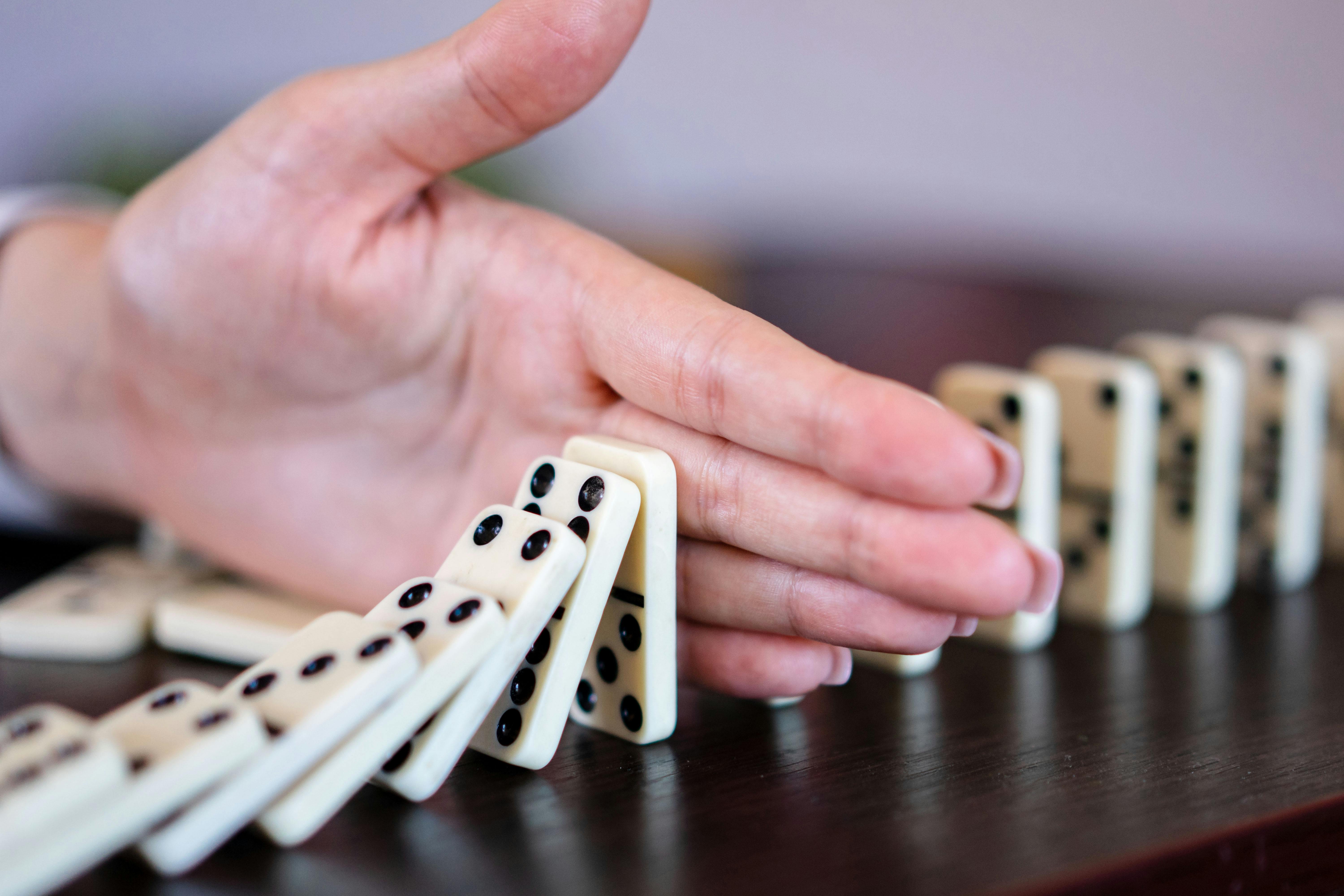 Domino effect representing hiring pipeline disruption
